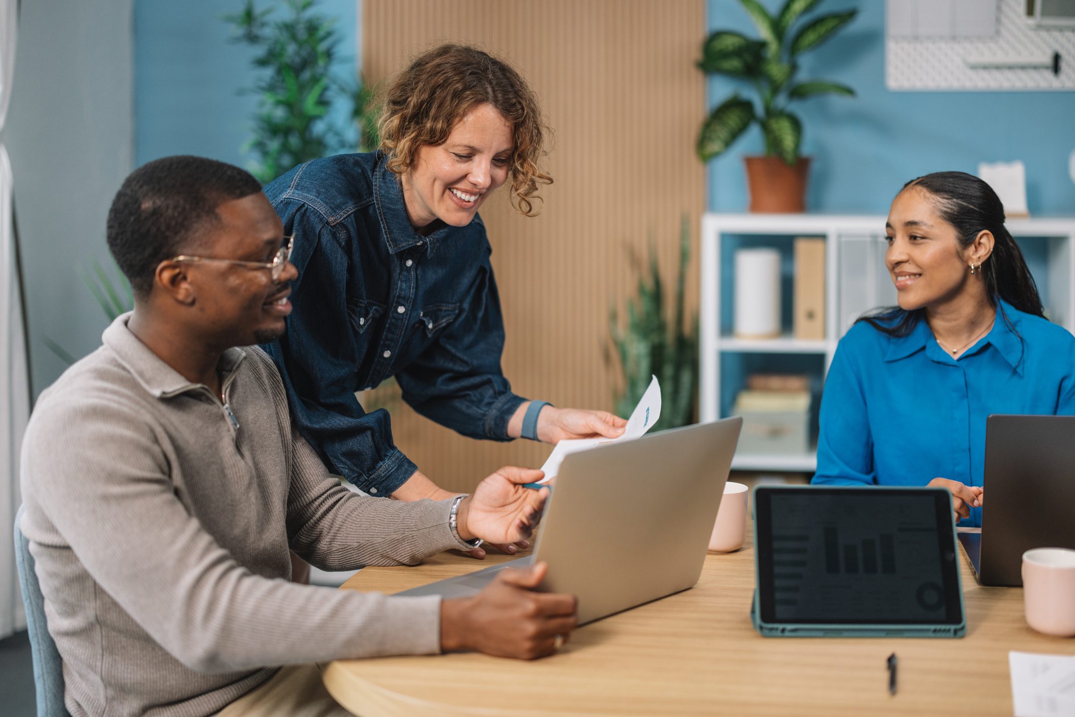 A collaborative team shares strategies during a meeting, highlighting teamwork and creativity in a bright office environment fostering innovation and connection among colleagues.